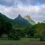Lush green mountains under a dramatic cloudy sky