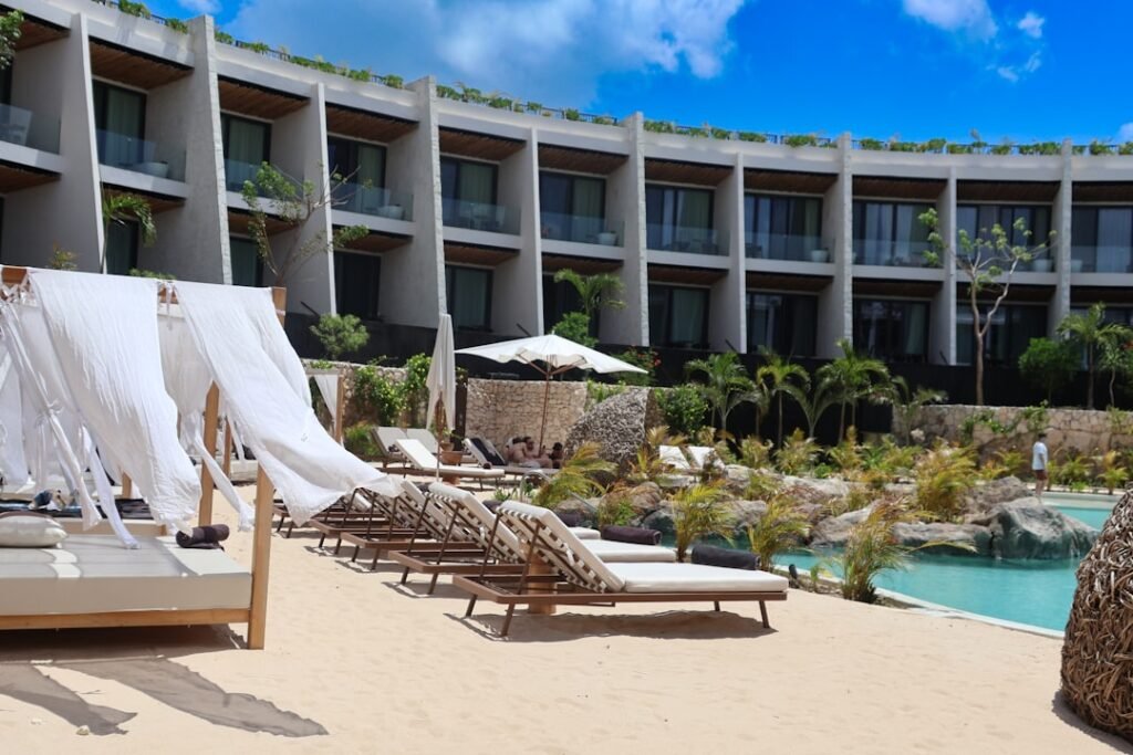 a hotel with a pool and lounge chairs