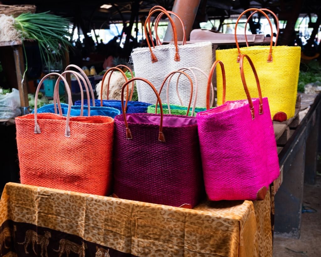 Colorful woven tote bags displayed at a market.
