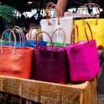 Colorful woven tote bags displayed at a market.