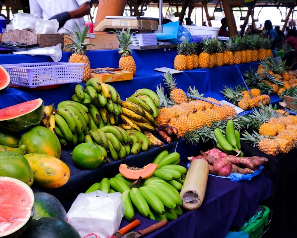 Fresh tropical fruits displayed at a market stall.