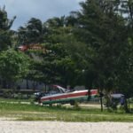 A small plane is parked on the beach