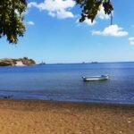 white boat on beach during daytime
