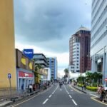 a street lined with tall buildings next to tall buildings