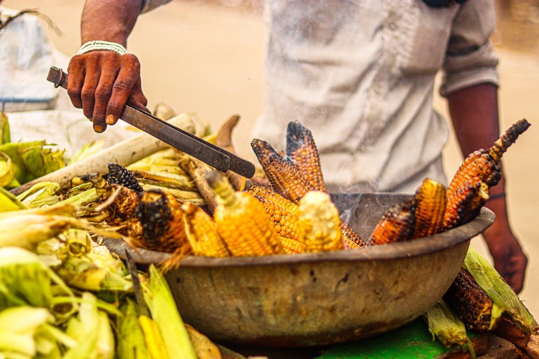 a person cutting a large pot of food