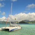 a sailboat in the water with mountains in the background