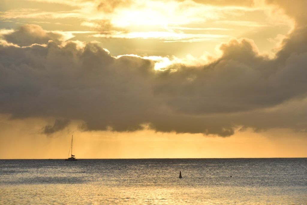 Sunset bathes the sea and clouds in golden light.