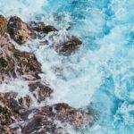 body of water beside hill
