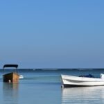 a boat sitting in the middle of a body of water