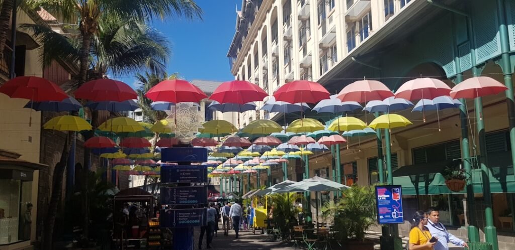 a group of people walking down a street under umbrellas