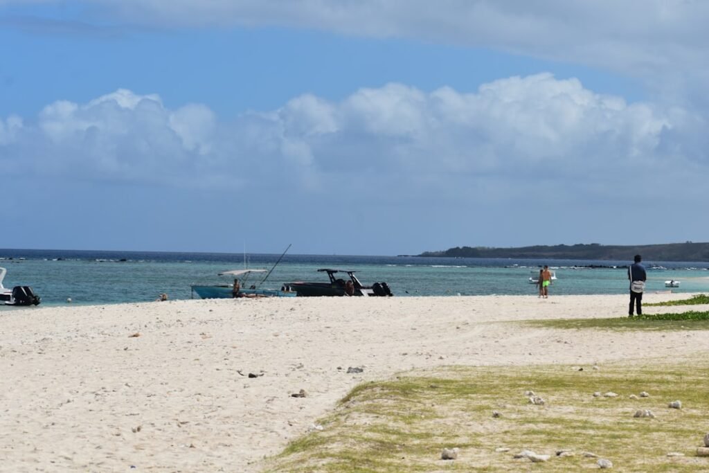 A group of people standing on top of a sandy beach