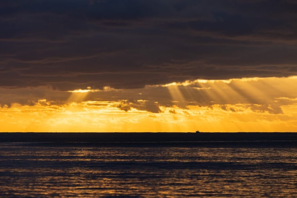 A large body of water under a cloudy sky