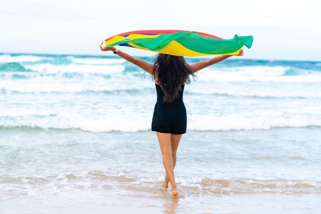 a woman holding a kite on the Riambel Beach Mauritius