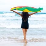 a woman holding a kite on the Riambel Beach Mauritius