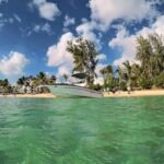 low-angle photography of powerboat near shore