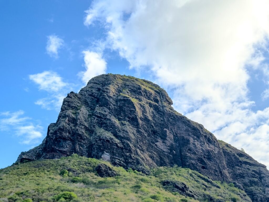 A rocky mountain peak against a blue sky.