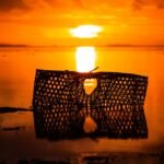 silhouette of fish net seashore