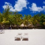 two loungers near hut during daytime