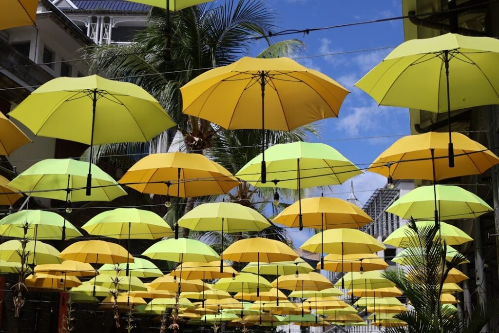 Yellow and green umbrellas hanging over a street. Mauritius weather