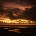 a sunset over a body of water