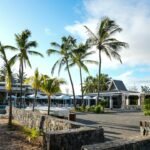 A resort with palm trees in the foreground
